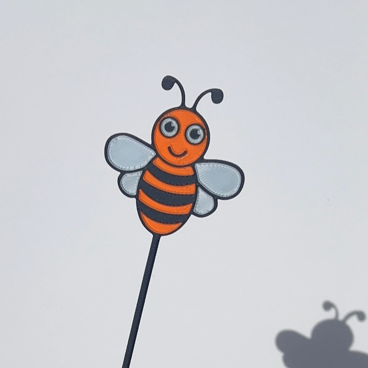 Orange, black and white translucent PLA bee decorative stem with a stained-glass-inspired design.