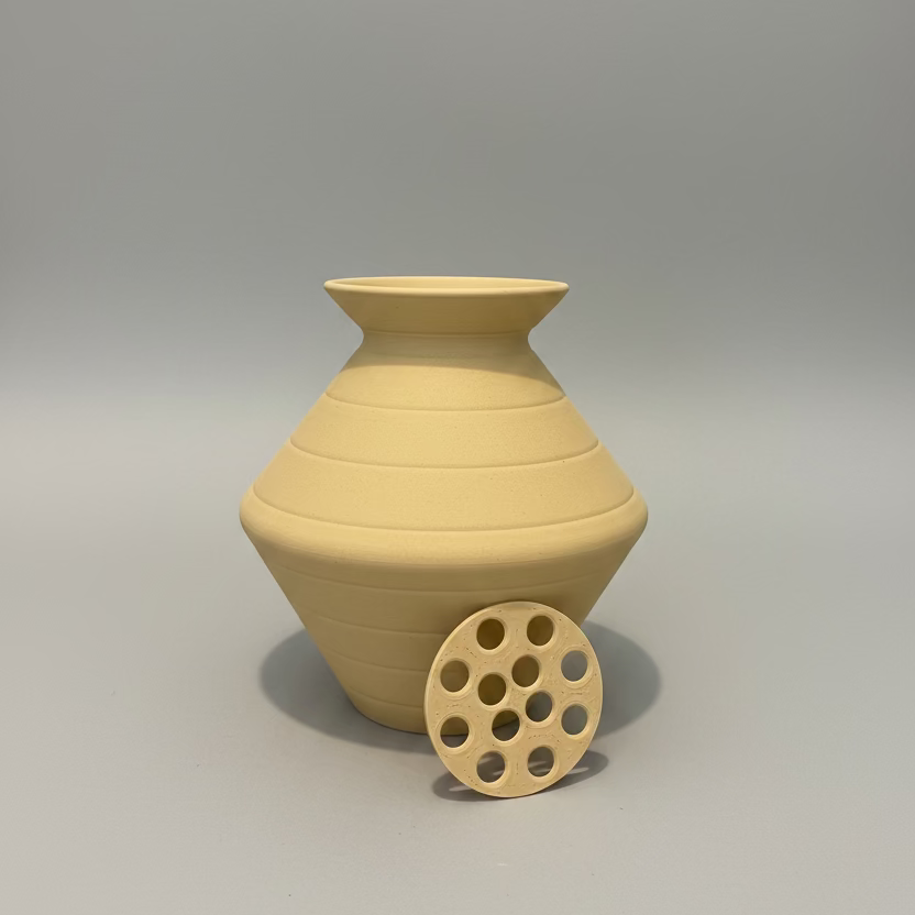 Beige ceramic vase with a circular base 