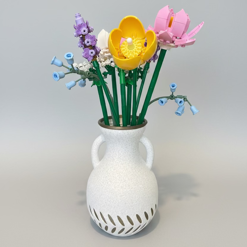 White vase with colourful artificial flowers 