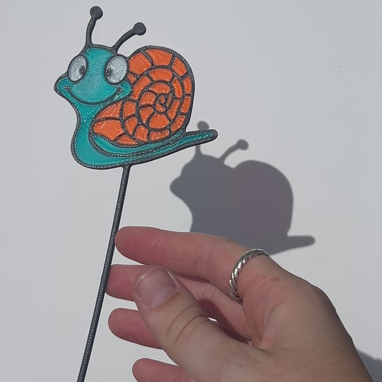 Turquoise and orange translucent PLA snail decorative stem with a stained-glass-inspired design.