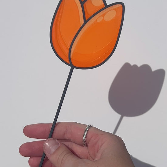 Orange translucent PLA tulip decorative stem with a black stained-glass-inspired outline.