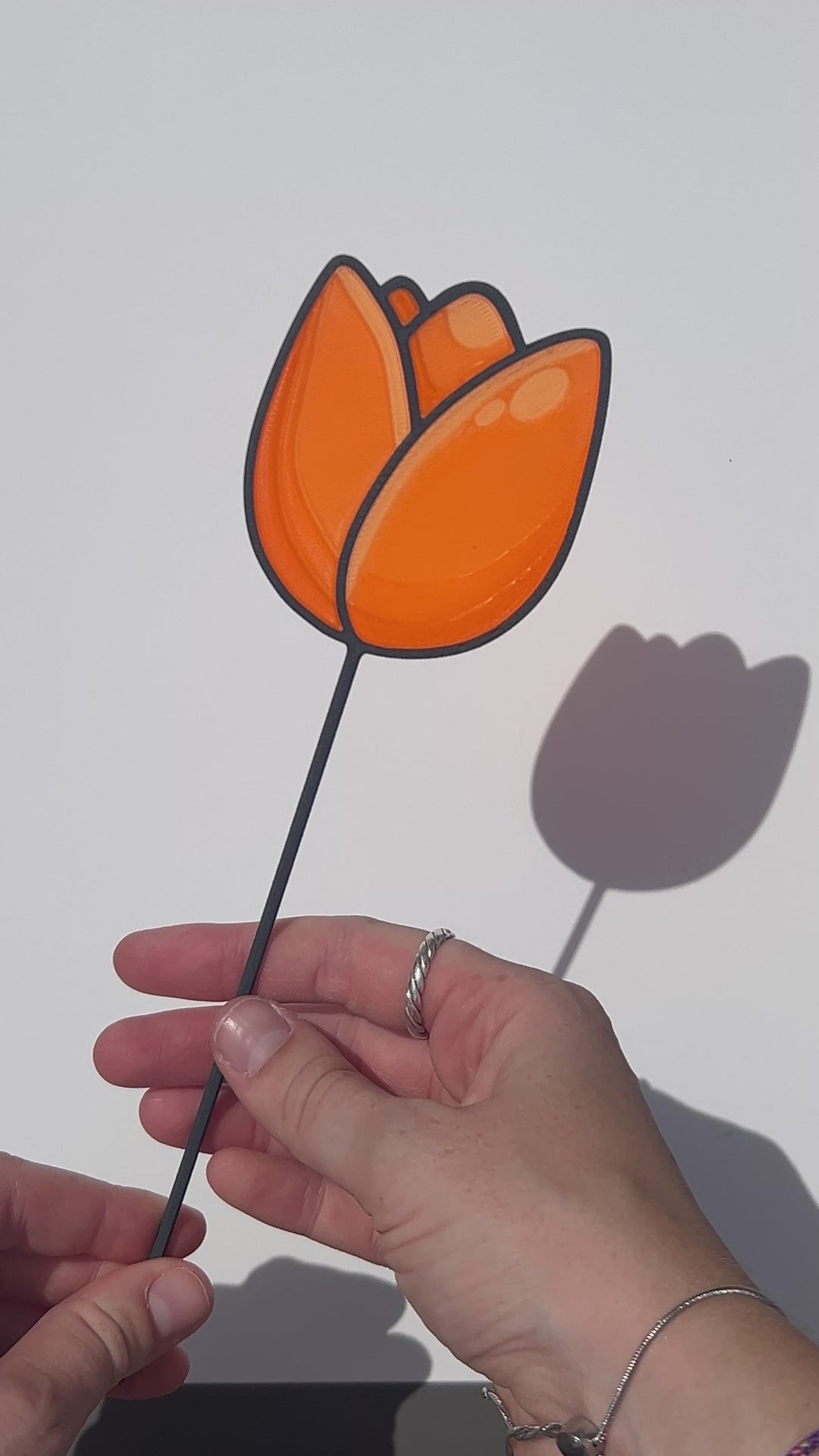 Orange translucent PLA tulip decorative stem with a black stained-glass-inspired outline.