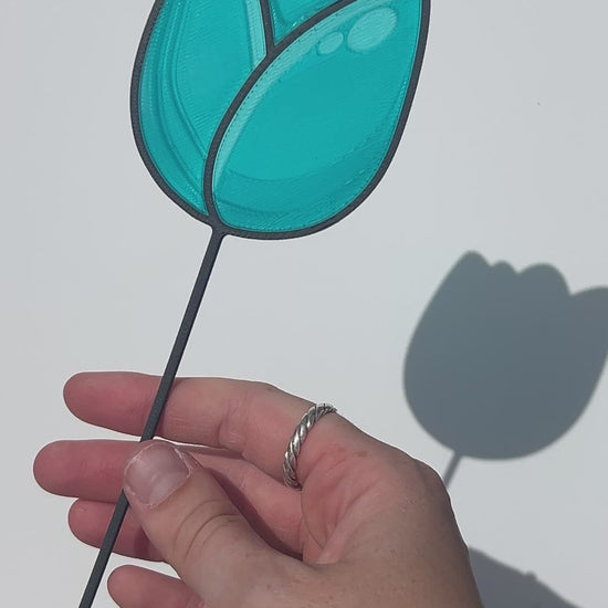 Turquoise translucent PLA tulip decorative stem with a black stained-glass-inspired outline.