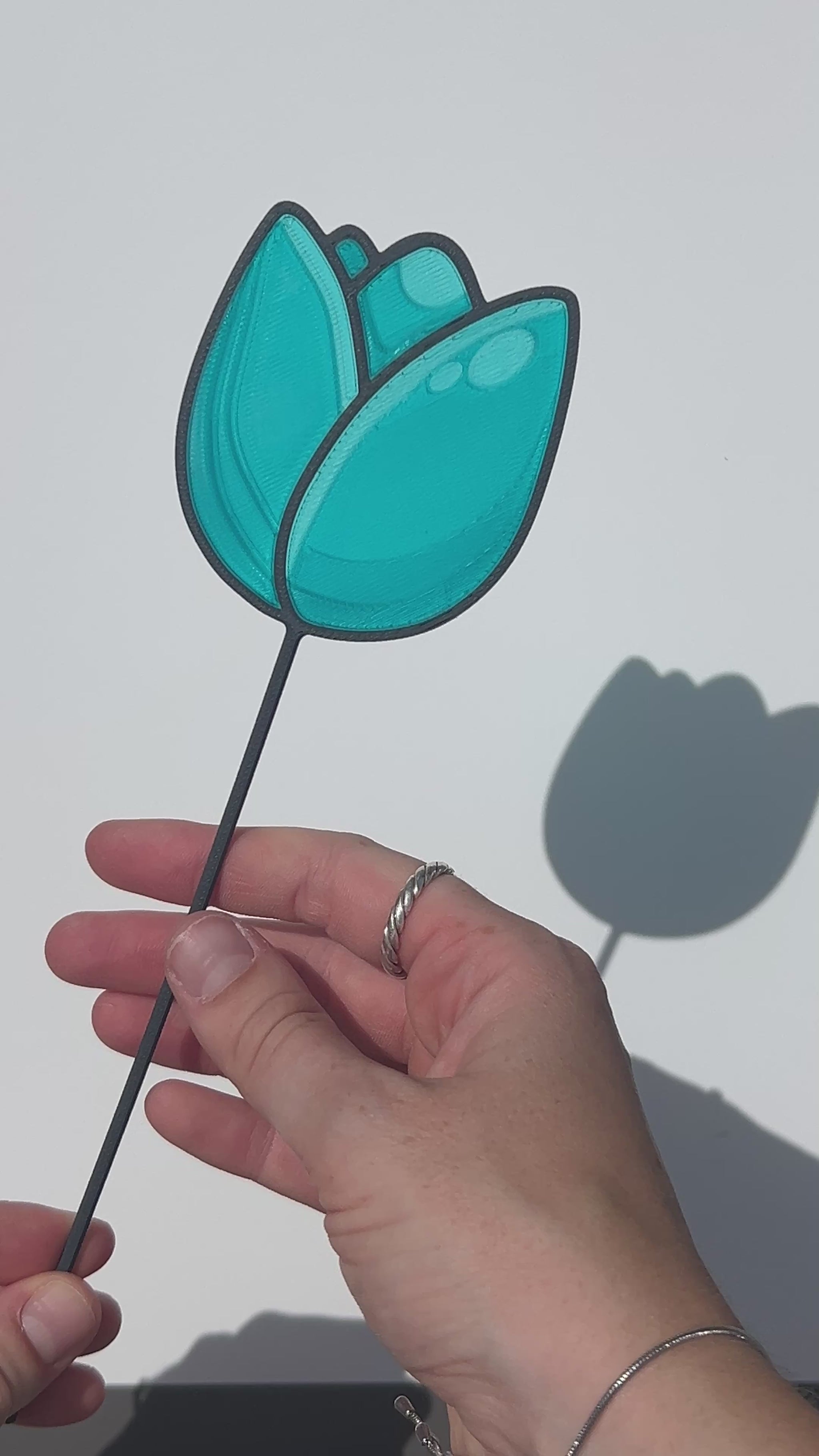 Turquoise translucent PLA tulip decorative stem with a black stained-glass-inspired outline.