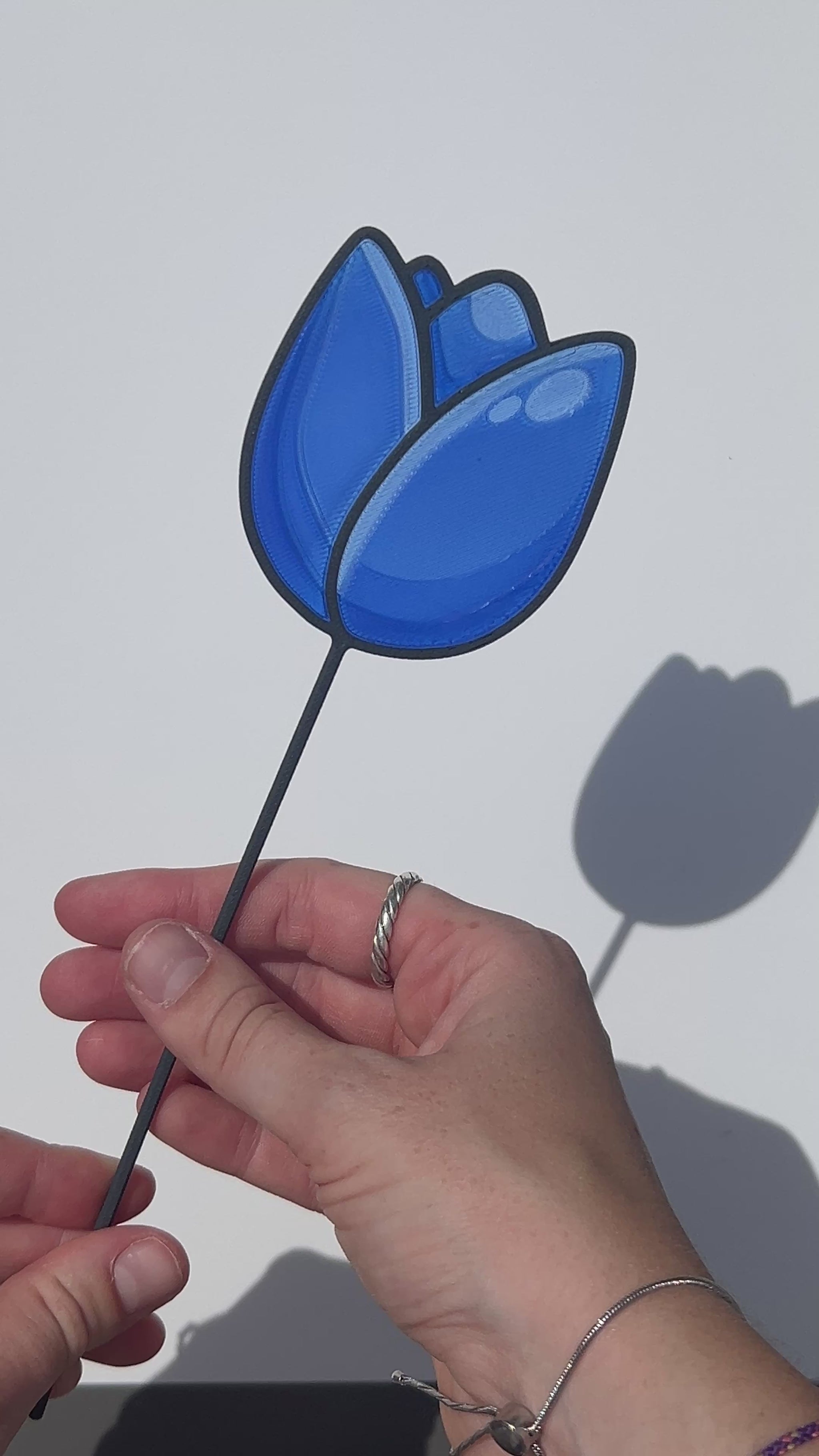 Blue translucent PLA tulip decorative stem with a black stained-glass-inspired outline.